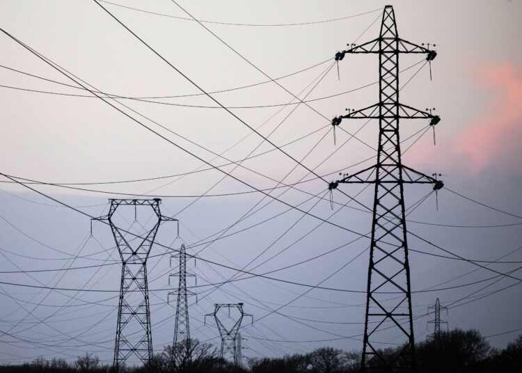 (FILES) This photograph taken on January 2, 2023 shows high voltage power lines in Cordemais, western France. - The electricity tariff shield, put in place by the French government since October 2021 to limit bill increases, will be maintained for another two years,  Minister of Economy Bruno Le Maire announced on April 21, 2023, on LCI. (Photo by LOIC VENANCE / AFP)